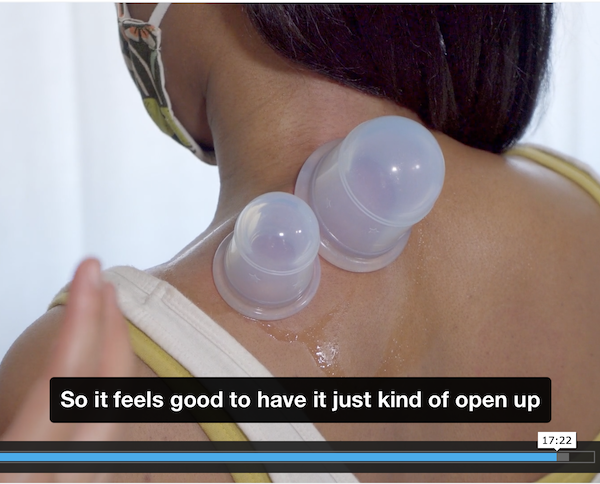 woman's back with two silicone cups on it. a pair of hands are shown to the side of the person demonstrating the cupping. a caption says "so it feels good to have it just kind of open up"