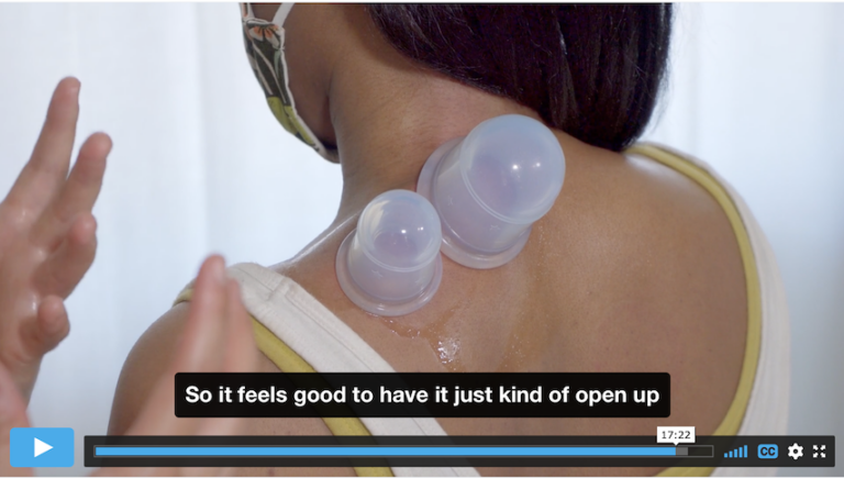 woman's back with two silicone cups on it. a pair of hands are shown to the side of the person demonstrating the cupping. a caption says "so it feels good to have it just kind of open up"