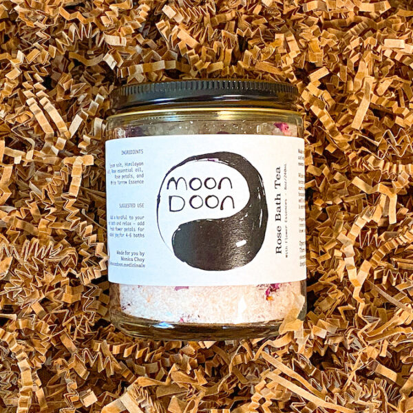glass jar of rose bath salts on brown crinkle paper